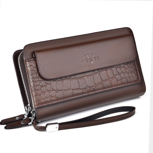 Brown crocodile-patterned clutch bag with a visible brand logo on a white background