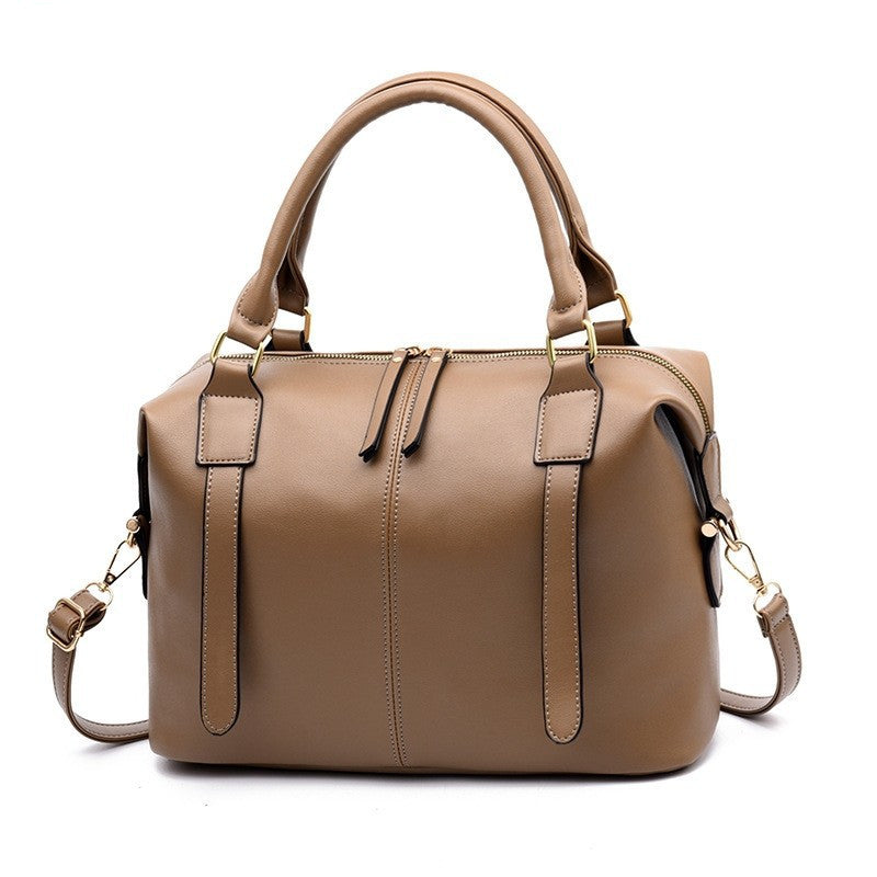 Brown handbag with gold accents on a white background