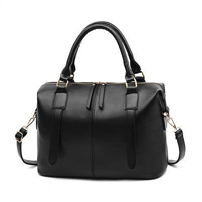 Black handbag with gold accents on a white background