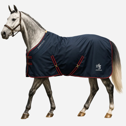 Horse wearing a navy blue blanket with red trim on a white background